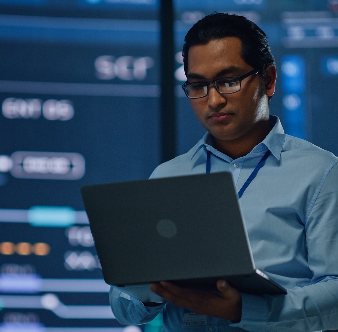 Worker with a badge using a laptop